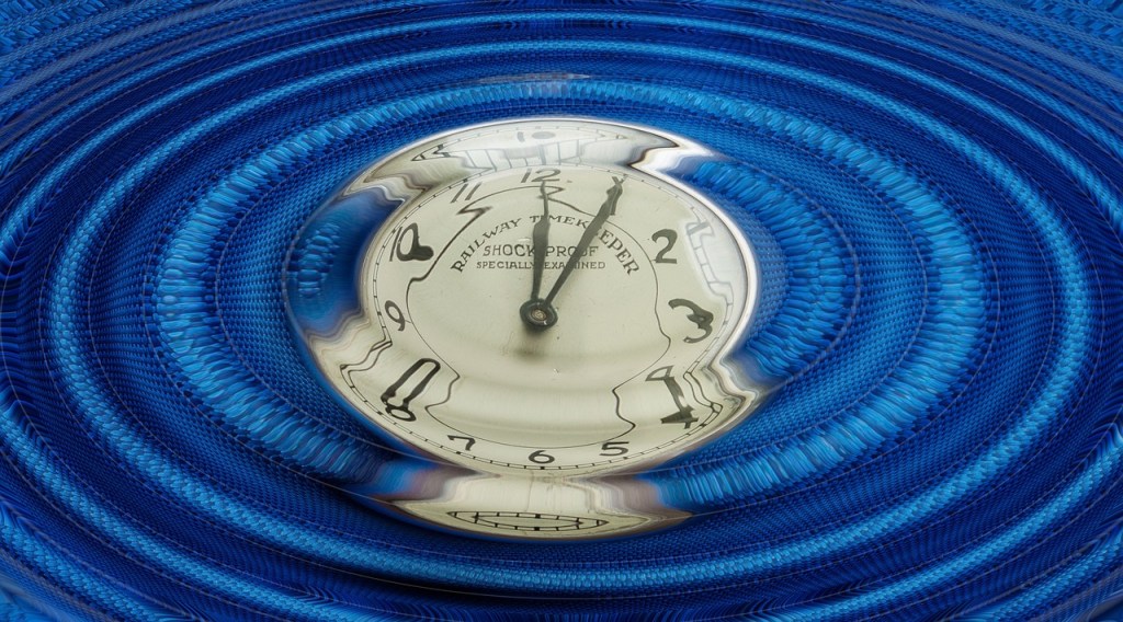 Clock submerged under blue ripples of sound
