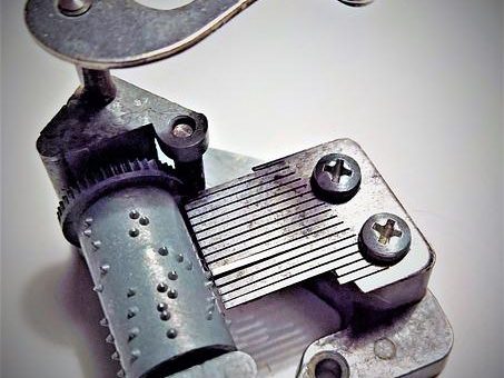 Inner workings of a music box with metal strips catching on pins