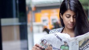 A professional Asian women reading the paper