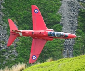 A red arrows jet flying low between hills