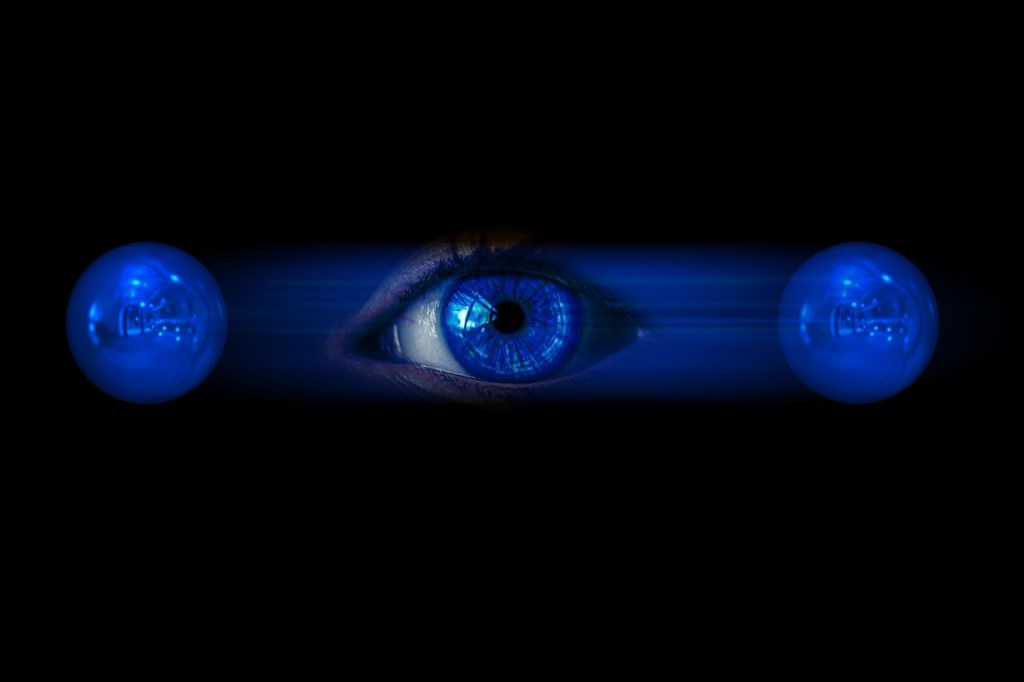 An eye looking at two blue spheres