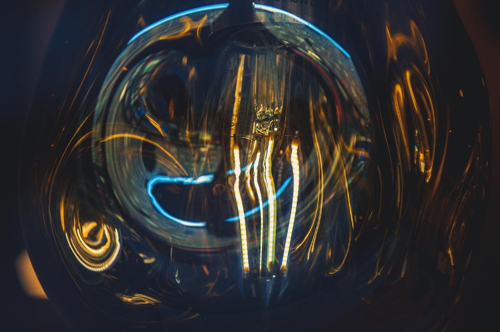 Light reflecting from strip bulbs in a light bulb