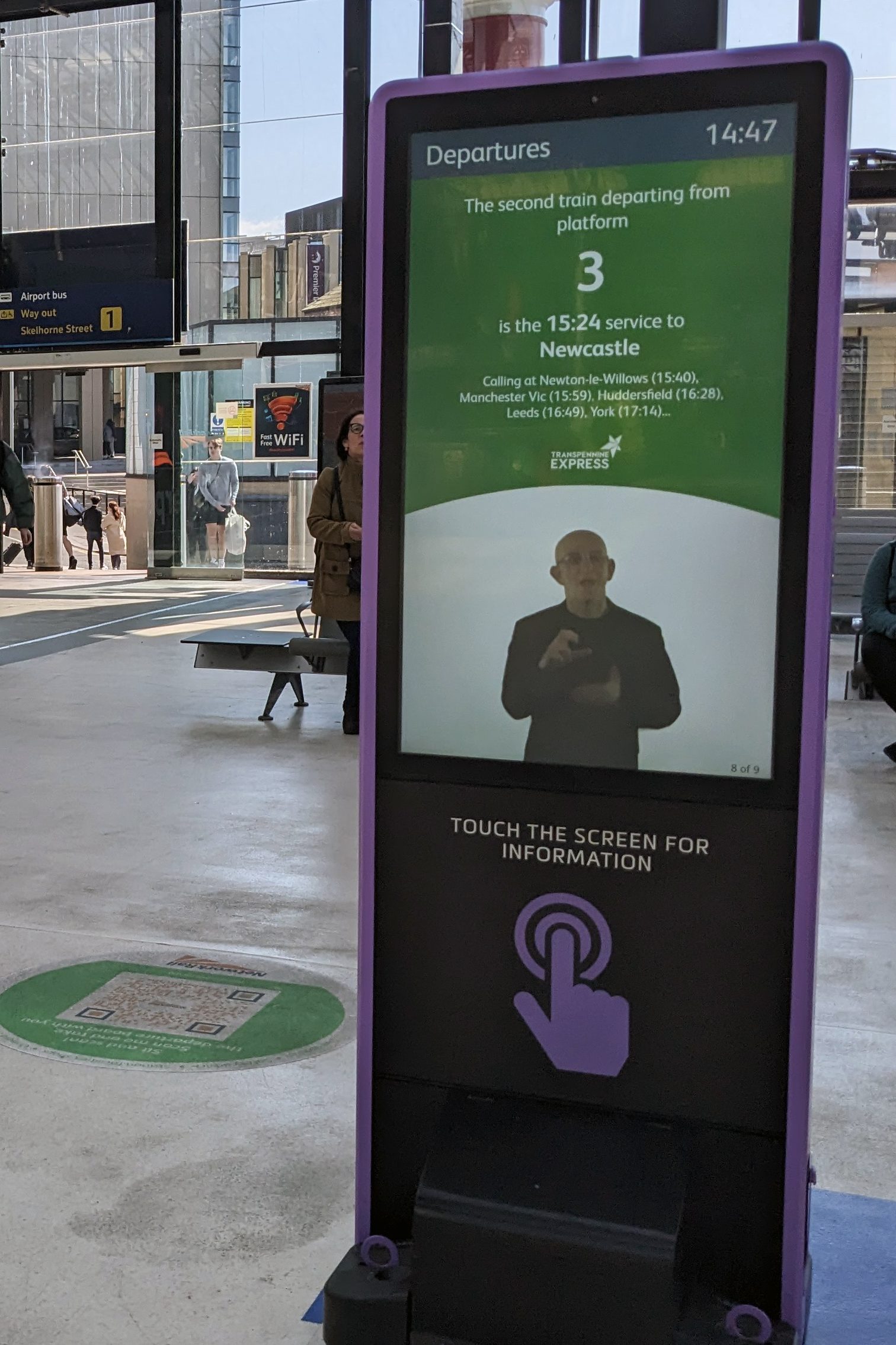 A train information screen with sign language