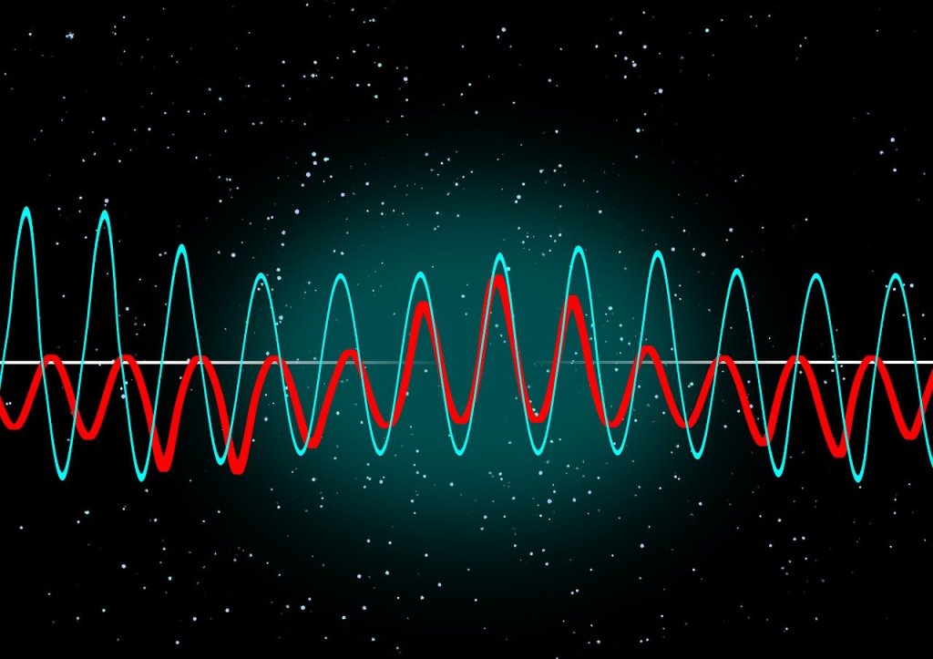 Two different coloured wave patterns superimposed on one anohter on a black background with random dots like a starscape.