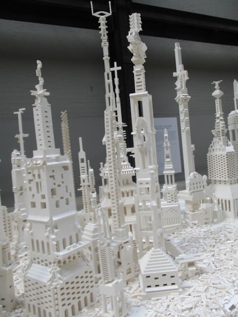 White lego buildings rising from rubble