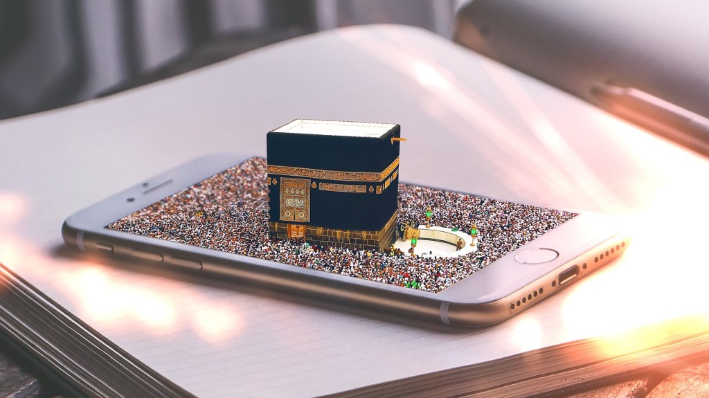 Kaaba, Mecca emerging from a smartphone screen

